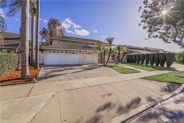 view of front facade featuring a garage, driveway, and stucco siding