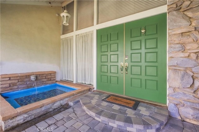 property entrance featuring stone siding