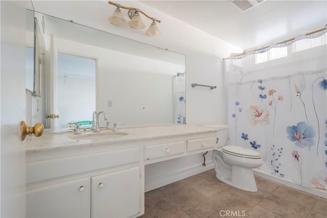 bathroom featuring vanity, toilet, a shower with curtain, and visible vents