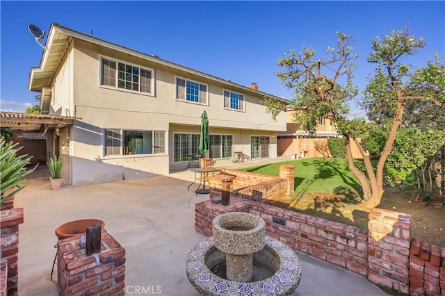 back of house featuring stucco siding and a patio