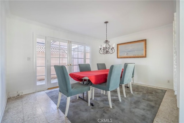 dining area featuring an inviting chandelier, baseboards, and ornamental molding