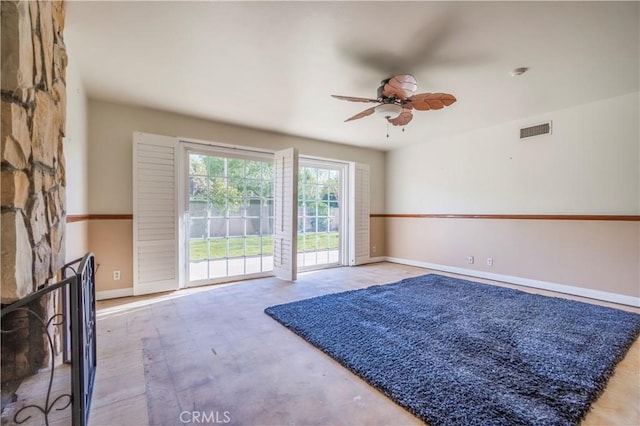 interior space featuring a ceiling fan, visible vents, and baseboards