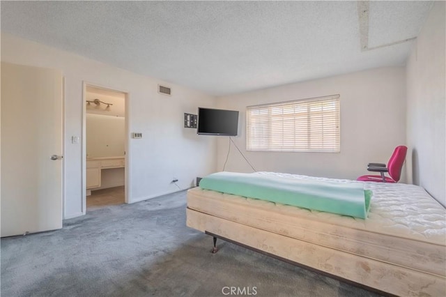 bedroom featuring visible vents, a textured ceiling, and carpet flooring