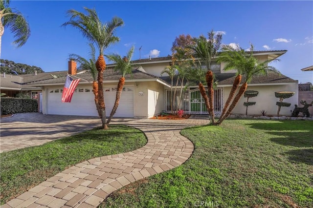 view of front of home with a front yard, a garage, driveway, and stucco siding