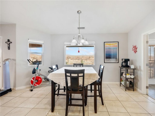 dining area featuring an inviting chandelier, light tile patterned floors, visible vents, and baseboards