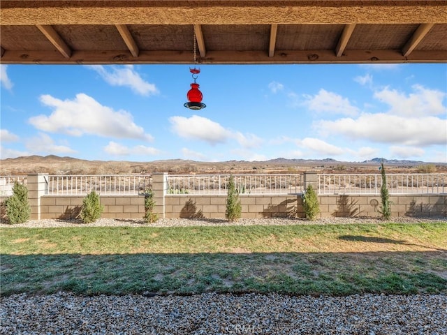 view of yard with a mountain view and fence