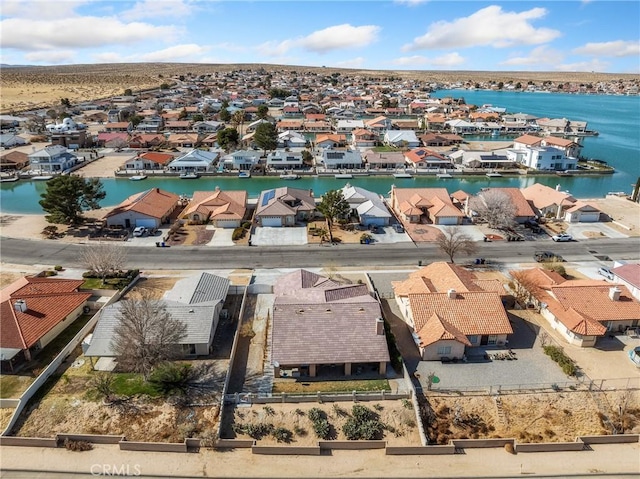 drone / aerial view with a residential view and a water view