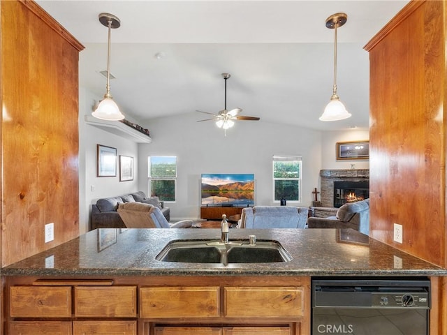 kitchen with a sink, dishwasher, open floor plan, and brown cabinetry