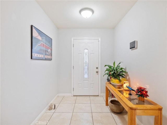 foyer entrance with baseboards and light tile patterned flooring