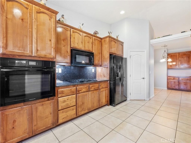 kitchen with tasteful backsplash, light tile patterned floors, brown cabinets, and black appliances