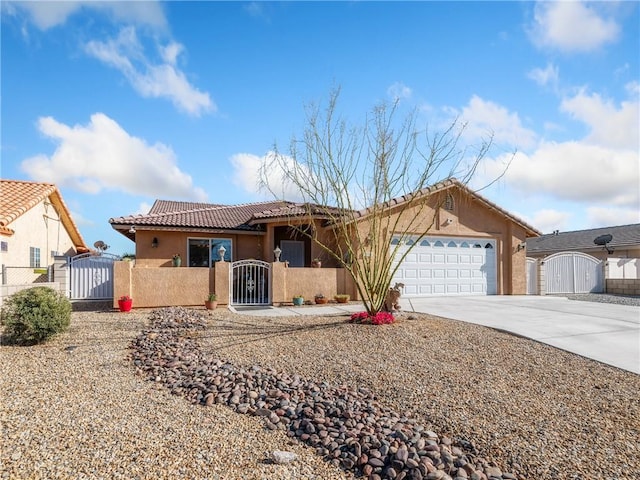 ranch-style home featuring a gate, an attached garage, and stucco siding