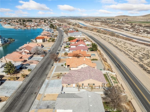 drone / aerial view with a residential view and a water view