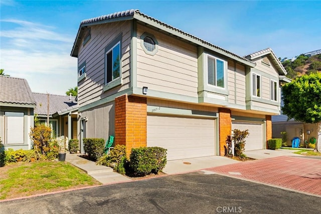 view of front of house featuring brick siding and a garage