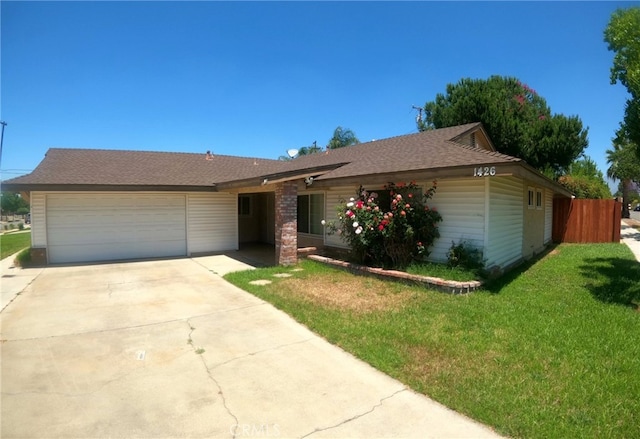 single story home featuring a front lawn, concrete driveway, an attached garage, and fence