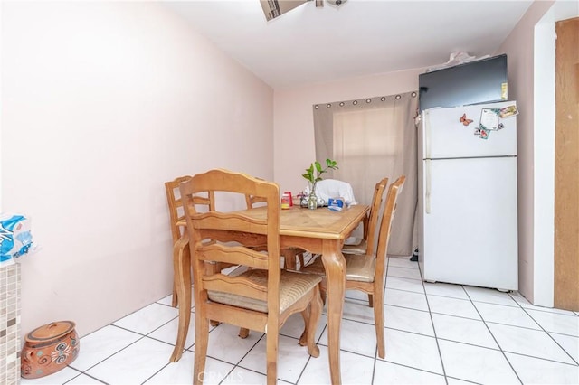 dining area with light tile patterned floors