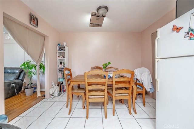 dining space featuring light tile patterned floors