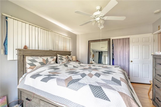 bedroom featuring light wood-type flooring, a closet, and a ceiling fan