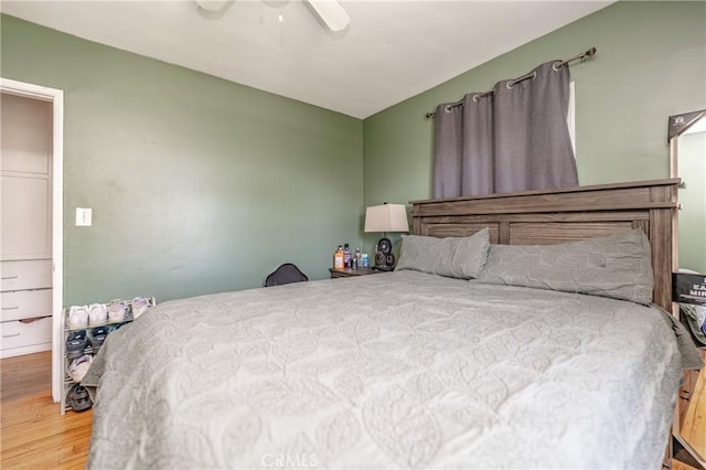 bedroom with a ceiling fan and wood finished floors