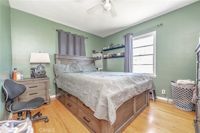 bedroom with light wood-style floors, baseboards, and ceiling fan