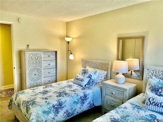 carpeted bedroom with a textured ceiling