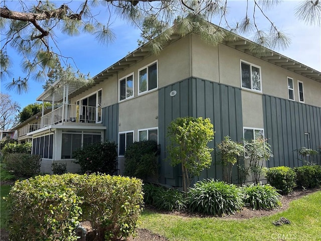 view of side of property with stucco siding and board and batten siding