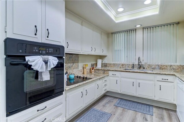 86 Calle Aragon Unit O, Laguna Woods, CA 92637 - kitchen with a sink, a raised ceiling, black appliances, and white cabinets