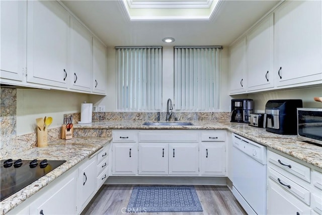 86 Calle Aragon Unit O, Laguna Woods, CA 92637 - kitchen with white dishwasher, black electric cooktop, stainless steel microwave, white cabinetry, and a sink
