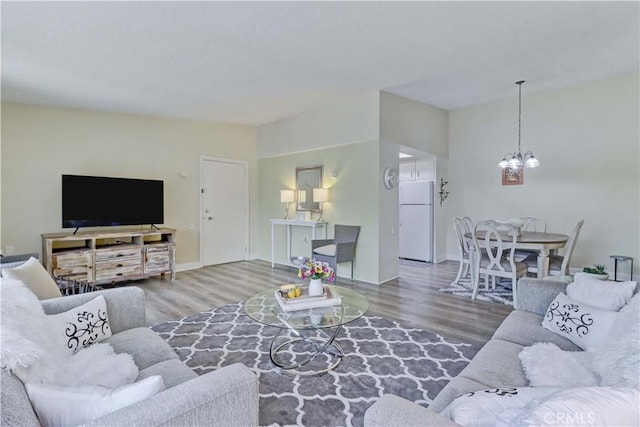 86 Calle Aragon Unit O, Laguna Woods, CA 92637 - living area featuring an inviting chandelier, baseboards, and wood finished floors