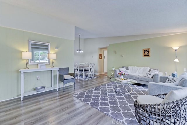 86 Calle Aragon Unit O, Laguna Woods, CA 92637 - living area with baseboards, vaulted ceiling, wood finished floors, and a notable chandelier