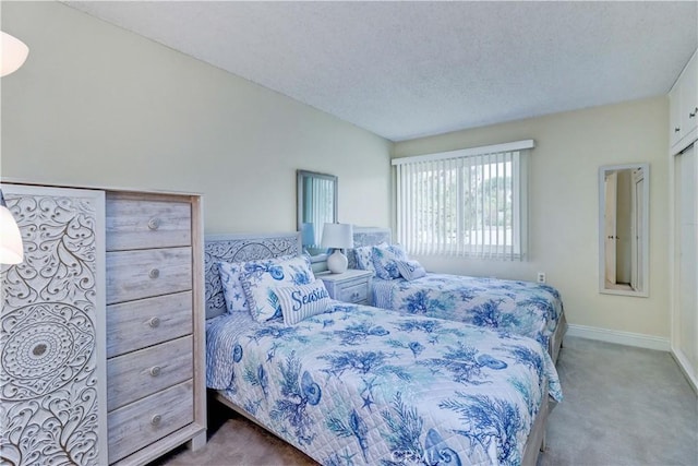 86 Calle Aragon Unit O, Laguna Woods, CA 92637 - bedroom with baseboards, a textured ceiling, and carpet