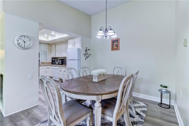 86 Calle Aragon Unit O, Laguna Woods, CA 92637 - dining room with light wood-style floors, baseboards, and a chandelier