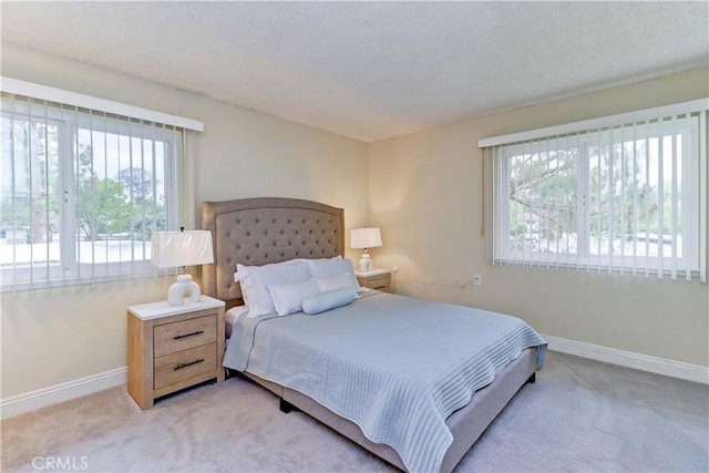 86 Calle Aragon Unit O, Laguna Woods, CA 92637 - bedroom with baseboards and light carpet
