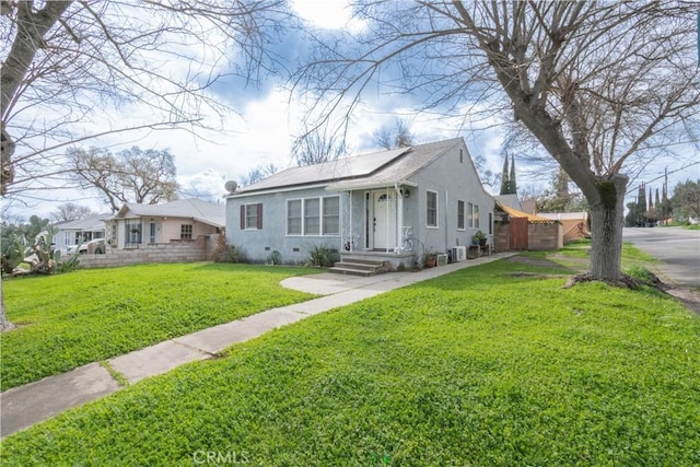 bungalow-style house featuring a front yard, stucco siding, central AC, and crawl space