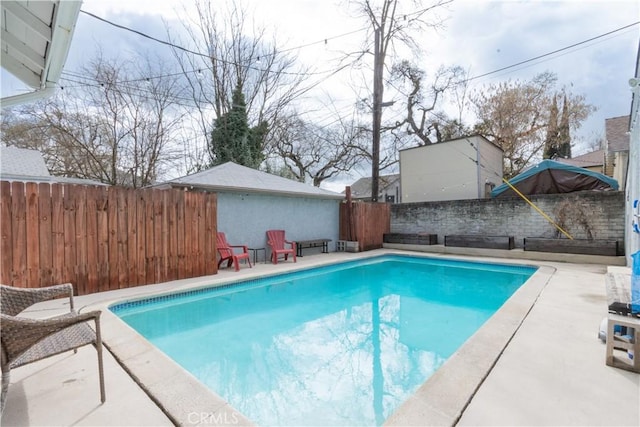 view of pool featuring a fenced in pool, a fenced backyard, and a patio area