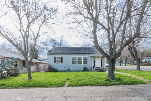 view of front of home with a front lawn, stucco siding, and crawl space