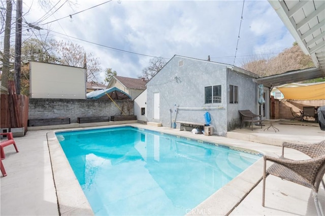 view of swimming pool featuring a fenced backyard, a fenced in pool, and a patio