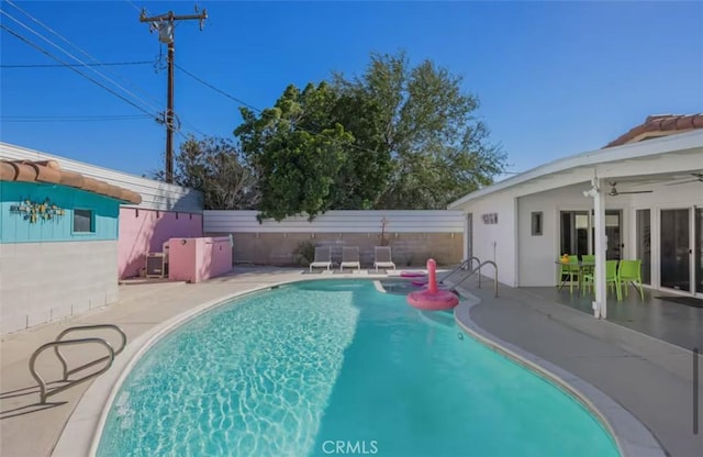 view of pool with a patio area, a fenced in pool, a ceiling fan, and fence