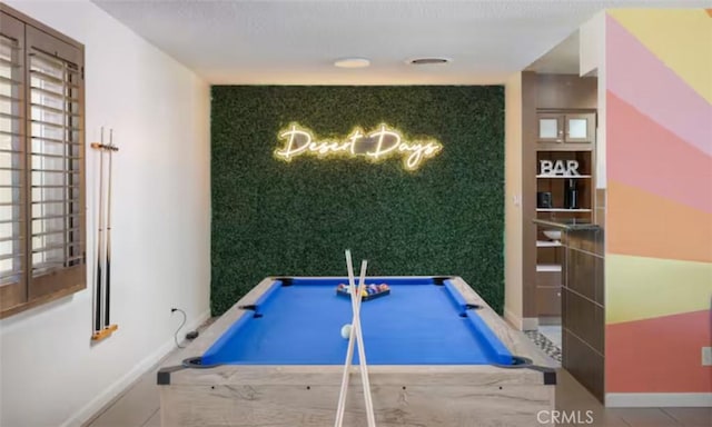 recreation room featuring pool table, an accent wall, and baseboards