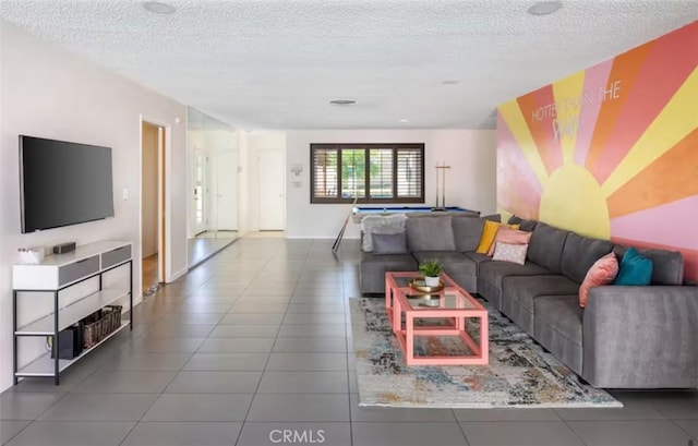 living area with a textured ceiling and tile patterned flooring