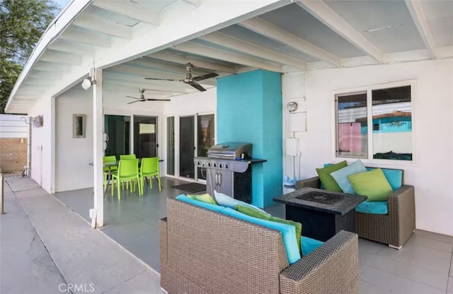 view of patio with a fire pit, area for grilling, and a ceiling fan