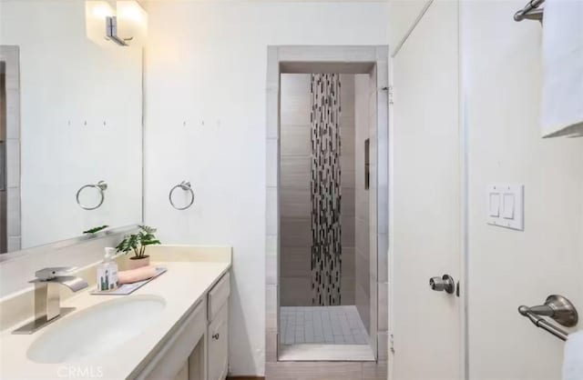 bathroom with a stall shower and vanity