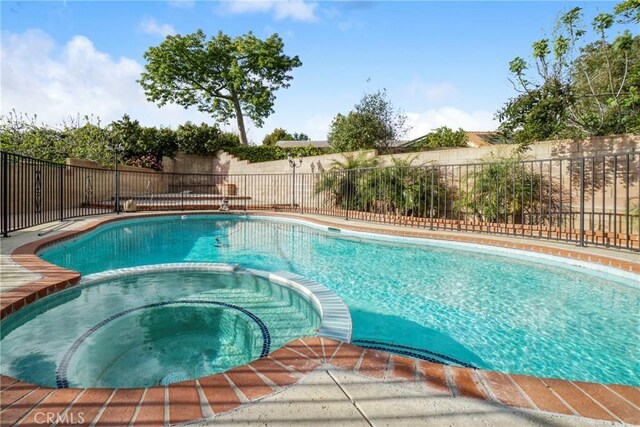 18429 Germain St, Porter Ranch, CA 91326 - view of swimming pool with a pool with connected hot tub and a fenced backyard