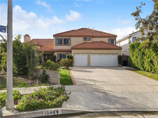 18429 Germain St, Porter Ranch, CA 91326 - mediterranean / spanish-style house with a tile roof, an attached garage, concrete driveway, and stucco siding