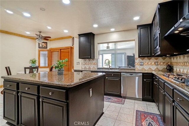 18429 Germain St, Porter Ranch, CA 91326 - kitchen featuring stainless steel appliances, a ceiling fan, a sink, a kitchen island, and recessed lighting