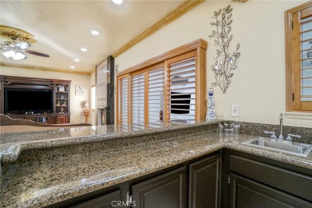 18429 Germain St, Porter Ranch, CA 91326 - kitchen with a sink, a ceiling fan, ornamental molding, recessed lighting, and stone countertops