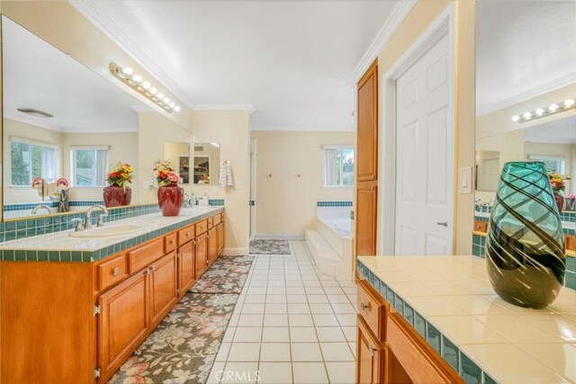 18429 Germain St, Porter Ranch, CA 91326 - bathroom with ornamental molding, double vanity, a garden tub, tile patterned flooring, and baseboards