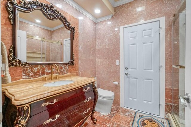 18429 Germain St, Porter Ranch, CA 91326 - full bathroom with ornamental molding, tile walls, vanity, toilet, and an enclosed shower