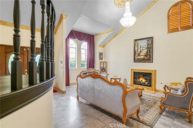 18429 Germain St, Porter Ranch, CA 91326 - living room featuring crown molding, a glass covered fireplace, baseboards, and a chandelier