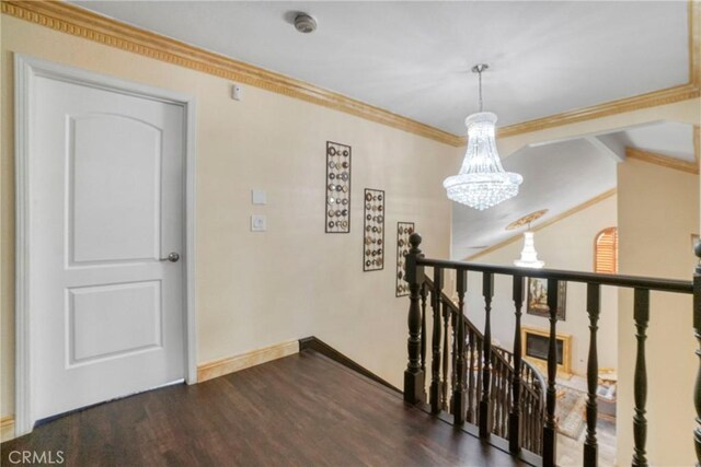 18429 Germain St, Porter Ranch, CA 91326 - hallway with a chandelier, an upstairs landing, wood finished floors, ornamental molding, and baseboards