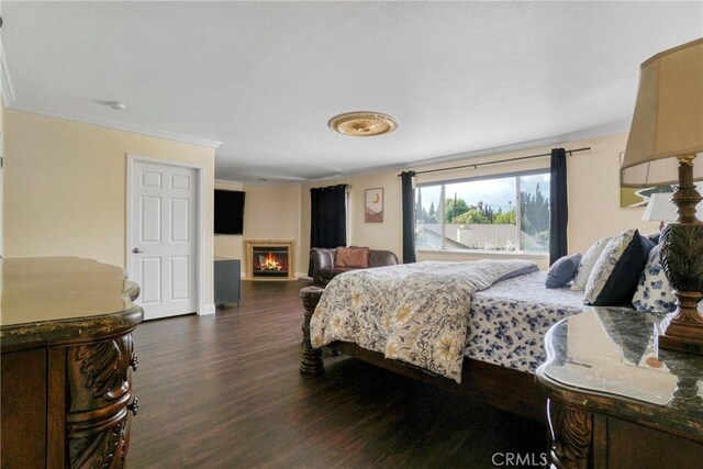 18429 Germain St, Porter Ranch, CA 91326 - bedroom featuring a warm lit fireplace, wood finished floors, ornamental molding, and baseboards